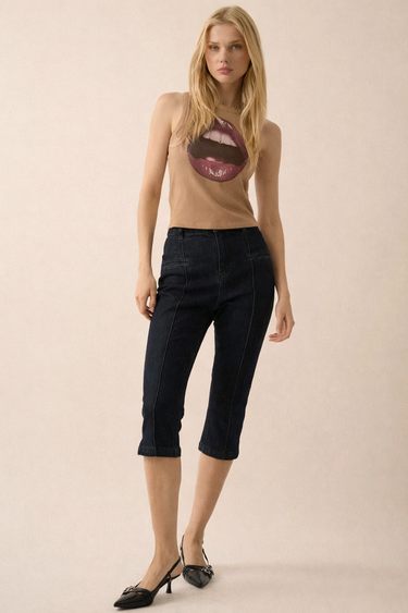 Abar Top taupe ribbed graphic tank styled with dark jeans and heels, showing fitted silhouette and cropped length in full-body studio look.