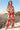 Akiabara Set worn by model, front view, red sleeveless top with matching wide-leg pants and palm-inspired print