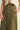 Altea Pant – relaxed wide-leg pants in olive cotton with high-rise waist, front view on model.