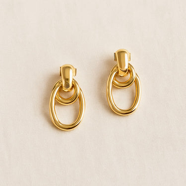 Asil Stud Earrings with elongated sculptural drop design and polished gold finish.