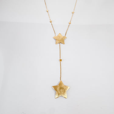Astra gold-tone star pendant necklace by Matte displayed on white surface