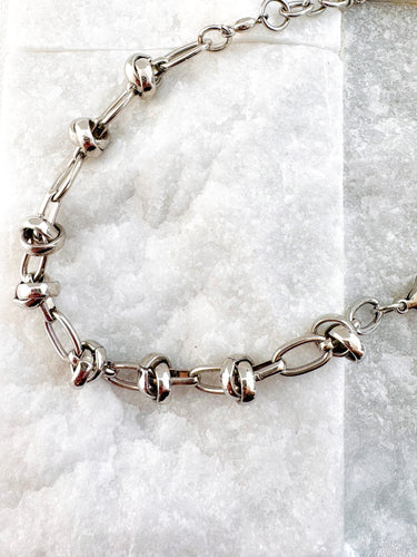 Silver plated link bracelet with bold knot details on marble background – Matte Jewelry Collection