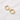 Awen Huggie Earrings – small polished gold huggie hoop earrings with a minimalist design, photographed on a soft neutral background.