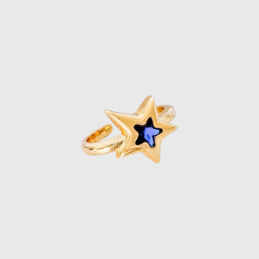 Gold ring with blue star-shaped crystal on silver surface – Azra Ring by Matte.