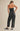 Back view of the Melina strapless jumpsuit showing relaxed straight-leg fit.