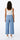 Relaxed wide-leg Tencel pants in light blue with natural fluid movement, shown in soft studio lighting on a model. Back view.