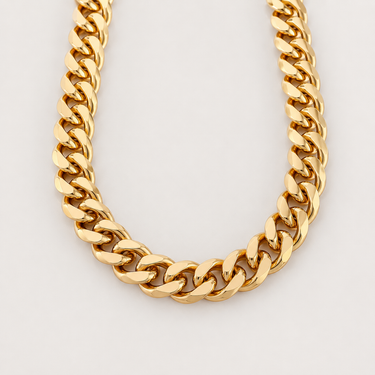 Belle Necklace chunky gold Cuban link chain necklace with oversized polished links on soft warm ivory background, luxury statement jewelry product photo with high-shine gold finish and bold modern silhouette.