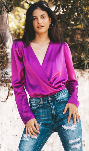 The bodysuit has a deep V-neckline and a flattering wrap design that creates a stylish cross-over effect at the chest.