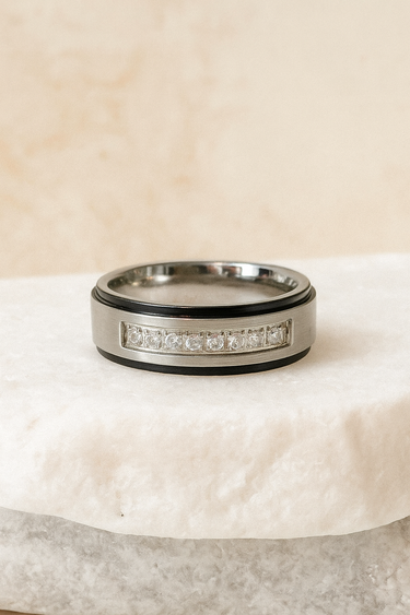 Silver ring with embedded zirconia stones displayed on neutral stone background – Brillance Ring by Matte