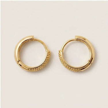 Brussels Huggie Earrings polished gold hoop earrings with textured bead detailing on the front and sleek rounded huggie silhouette on neutral background