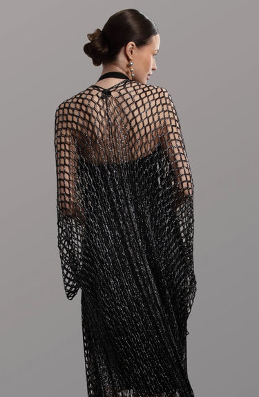 Chalat Kimono worn by model, back view, showing open-knit texture and flowing fringe movement.