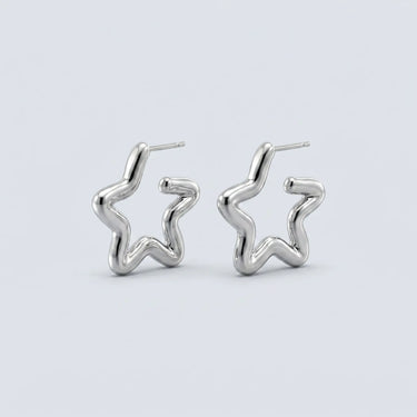 Charleroi silver star hoop earrings with sculptural abstract silhouette, polished silver finish, and modern statement jewelry styling on a soft light gray background.