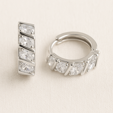 Cillian Huggie Earrings with geometric faceted stones and polished silver huggie design.
