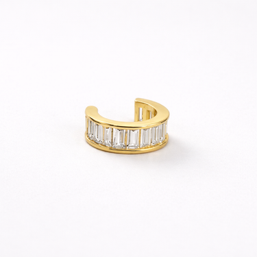 Gold ear cuff with baguette cut diamonds on a white background
