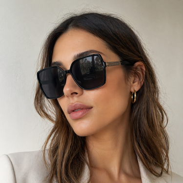 Dalia Sunglasses worn on model featuring oversized square black frame with dark lenses for a bold, modern look.