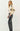 Side view of black faux leather pants showing high waist and smooth finish.