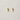 Gold capsule-shaped stud earrings on neutral linen background – Elodie Stud Earrings by Matte