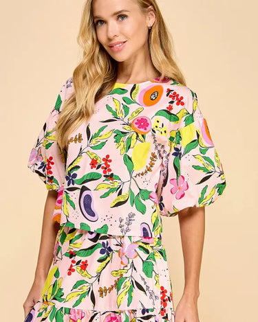 Model wearing the Enus Top in abstract print cotton with short balloon sleeves and relaxed fit.