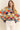 Model wearing Eon Sweater, multicolor knit with wave pattern, front view.