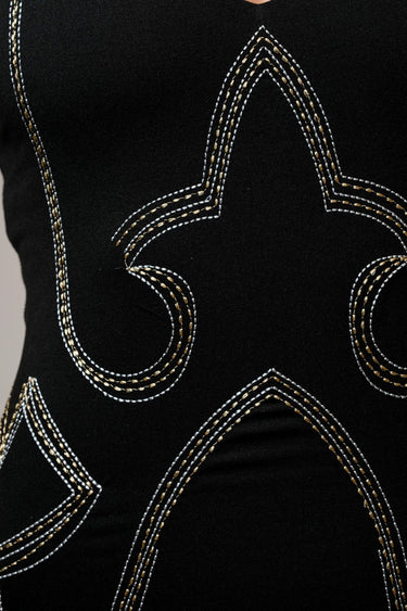 Ephesus Bodysuit in black with bold metallic embroidery, close up.
