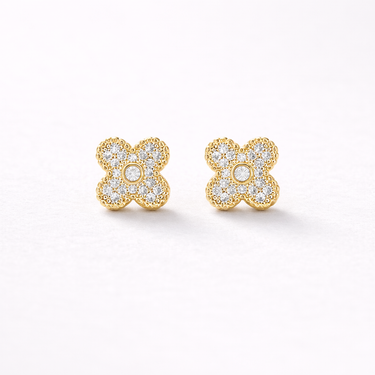 Fallon Stud Earrings featuring small floral cluster design with pavé-set zirconia stones in gold setting, displayed as a pair on a soft light gray background with subtle shadow, dainty everyday stud earrings