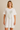 Woman wearing Fierce T-Shirt Dress in white with metallic leopard print, casual relaxed fit.