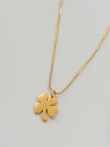 Four Leaf Clover Necklace featuring a gold-plated clover pendant on an adjustable chain, displayed against a light background.