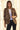 Close-up of women's leopard print blazer featuring structured shoulders, notched lapels, and ruched three-quarter sleeves.