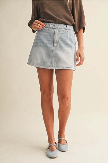 Girona Mini Short worn by model front view with light-wash denim finish.