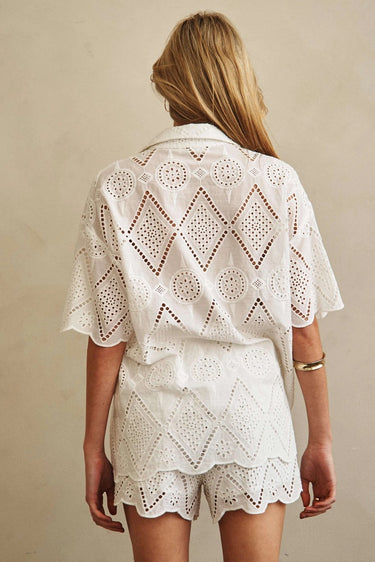 Godeth Blouse back view showing white eyelet texture, short sleeves, and scalloped hem with matching shorts.