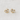 Kuga Stud Earrings featuring gold heart-shaped settings with clear crystals on a soft beige fabric background.