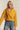 Mustard cropped coat paired with light blue jeans, casual chic look