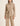 Woman wearing Hailee Lounge Sweater Set in beige, featuring knit turtleneck top with waist tie and wide-leg pants.