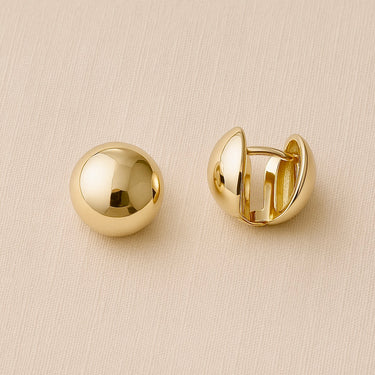 Halott Huggie Earrings with polished finish and rounded huggie design.