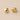 Halott Huggie Earrings with polished finish and rounded huggie design.