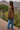 Brown oversized pullover sweater with U.S. flag knit pattern on the front, long sleeves.
