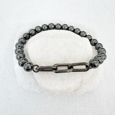 Homa Bracelet with polished beads and bold chain link accent on neutral stone background – Matte Jewelry Collection