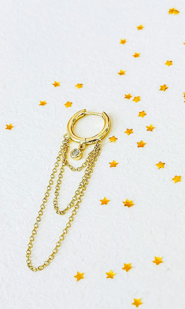 Inami gold hoop earring with chain on a white background with yellow stars