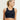 Woman wearing a black sports bra with star designs on a plain background