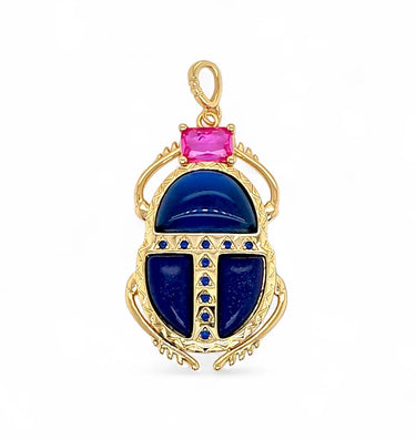 Kina Pendant gold scarab charm with deep blue enamel wings and pink top stone front view on neutral background showing intricate detailing and polished finish.