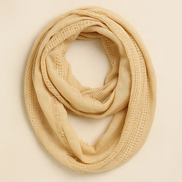 Kisiwa Infiniti Scarf in beige knit fabric, infinity loop design, soft textured neutral scarf styled for fall and winter by Matte.