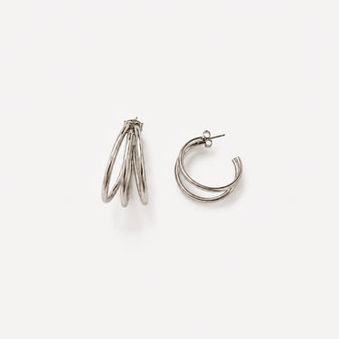 Liége Hoop Earrings featuring polished silver-plated multi-band hoop earrings with layered rounded curves, smooth mirror finish, secure hinged closure, lightweight design, and bold contemporary style, displayed on a soft white background.