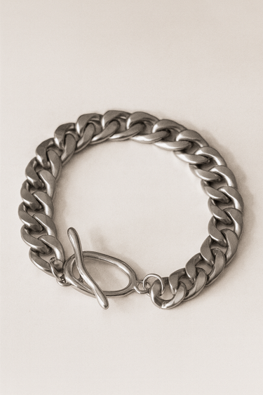 Link Bracelet — polished silver chain bracelet with bold toggle clasp on beige marble background, modern jewelry by Matte.