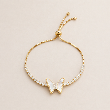 Llun Bracelet gold butterfly bracelet with pearl wings and shimmering stones on neutral background, showing adjustable chain and delicate design
