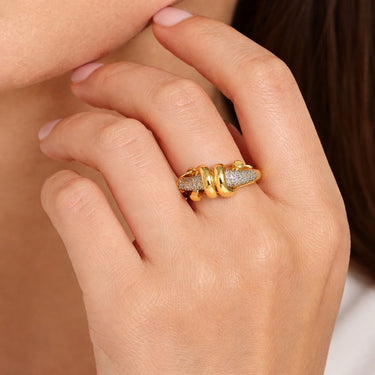 Two-tone gold and diamond triple link ring with pavé diamonds worn on woman’s finger close-up hand model