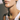 Lucky Necklace worn on model featuring four-leaf clover pendant in textured gold.