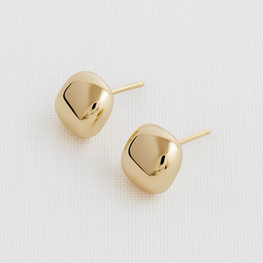 Maelis Stud Earrings — gold plated sculptural stud earrings with rounded square shape and mirror finish on beige linen background, elegant jewelry by Matte.