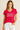 Woman wearing the vibrant pink Magic Tee with silver “Make today Magic” lettering, paired with white jeans against a neutral background.