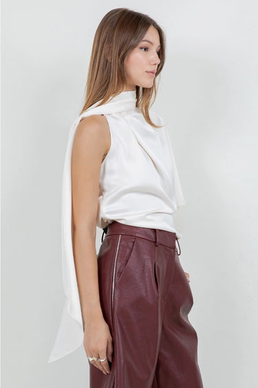 Maratea Blouse worn by model, side view, highlighting asymmetric design and soft scarf wrapped around.