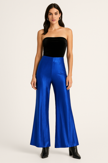 Model wearing electric blue metallic pants with black top and boots, front view.